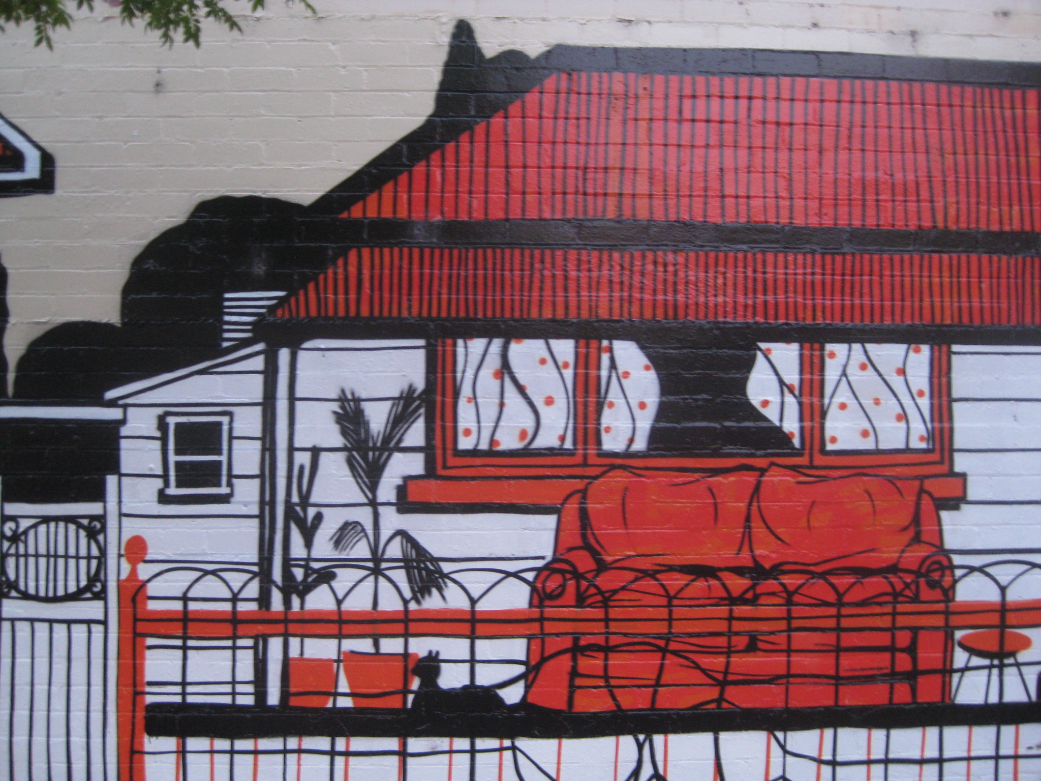 footscray graffiti orange black white house with a couch and cat on the porch
