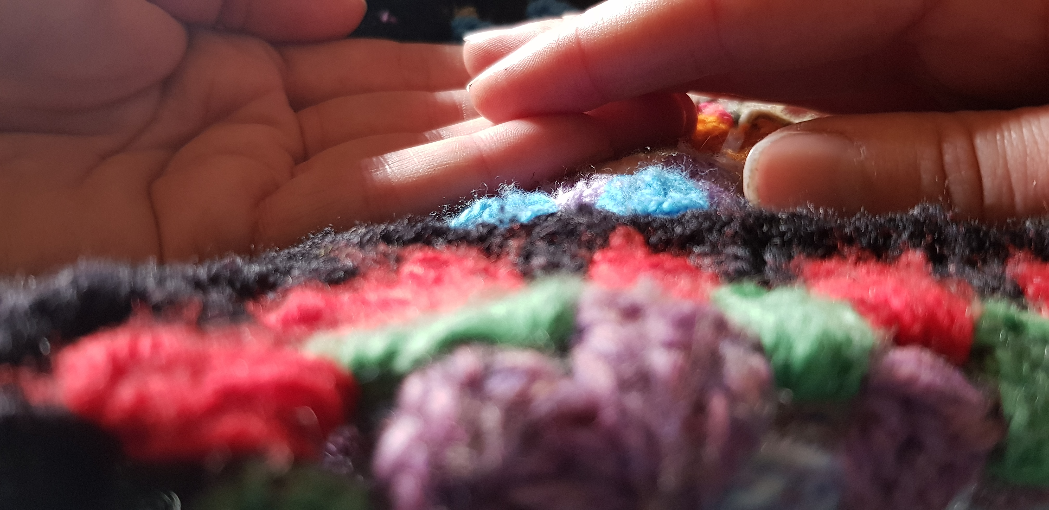 hands touching colourful crotchet balnket talitha fraser nz poet